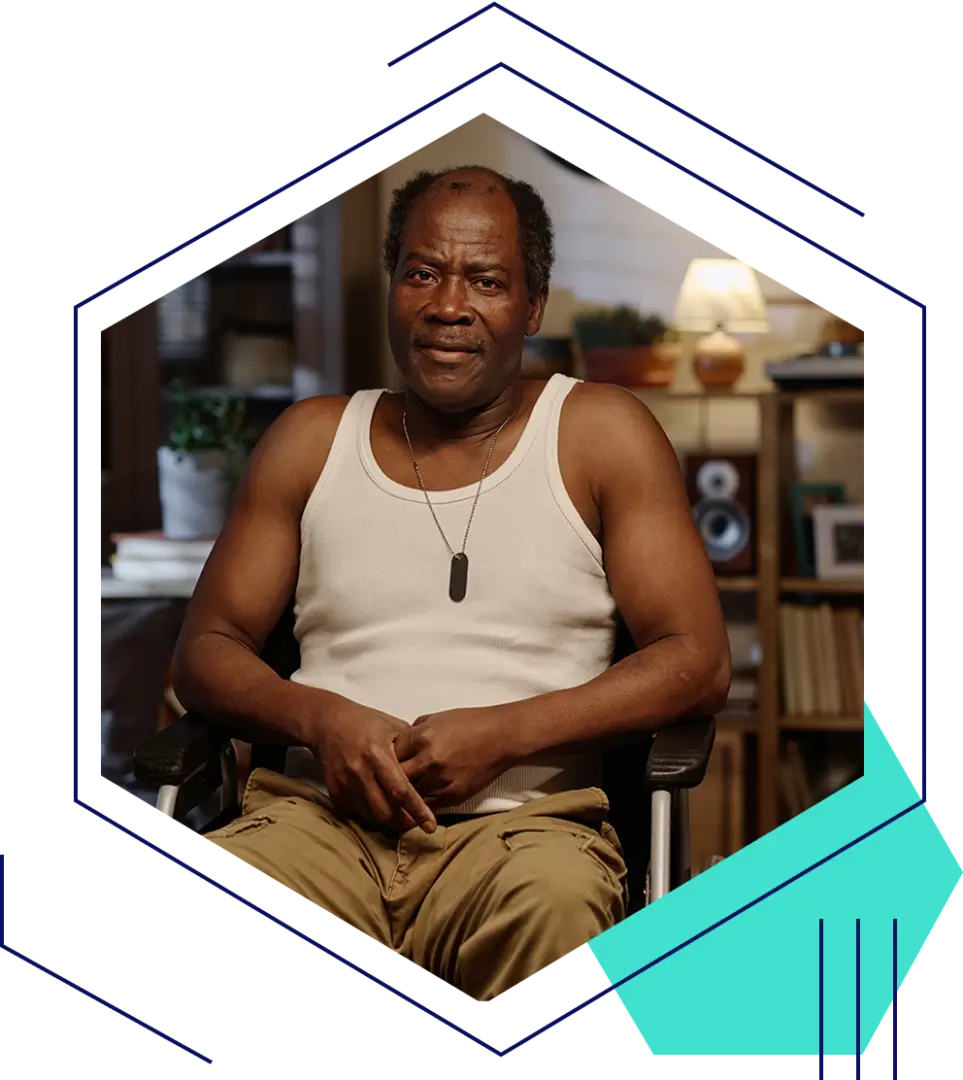 IMG.png (1) Man sitting in a chair, wearing tank top.